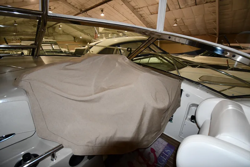 Slide: The Image of 2006 Sea Ray 40 Sundancer interior with covered dashboard in a showroom. - 55