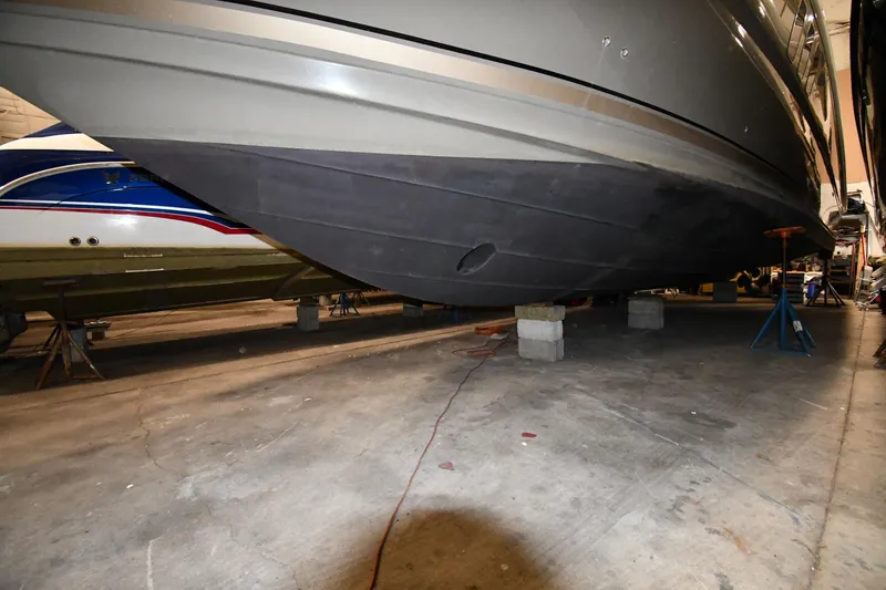Slide: The Image of 2006 Sea Ray 40 Sundancer yacht in storage, supported by blocks and stands. - 56