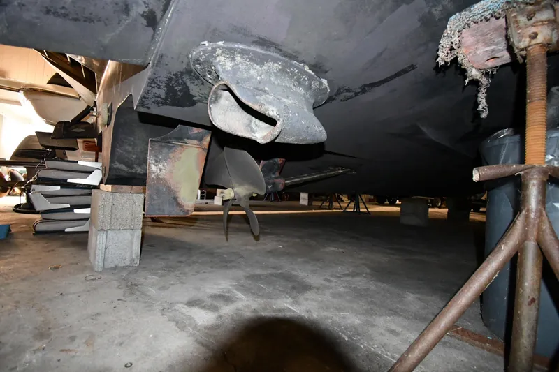 Slide: The Image of 2006 Sea Ray 40 Sundancer boat underside with propeller and rudder in dry dock. - 58