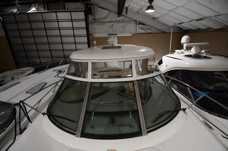 Slide: The Image of 2006 Sea Ray 40 Sundancer yacht in indoor storage, showcasing sleek design and radar equipment. - 6