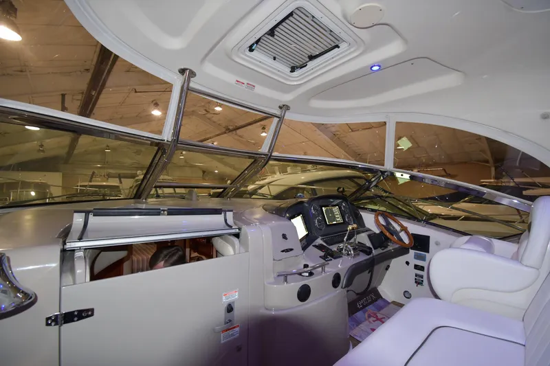 Slide: The Image of Interior of 2006 Sea Ray 40 Sundancer yacht cockpit with modern controls and seating. - 8