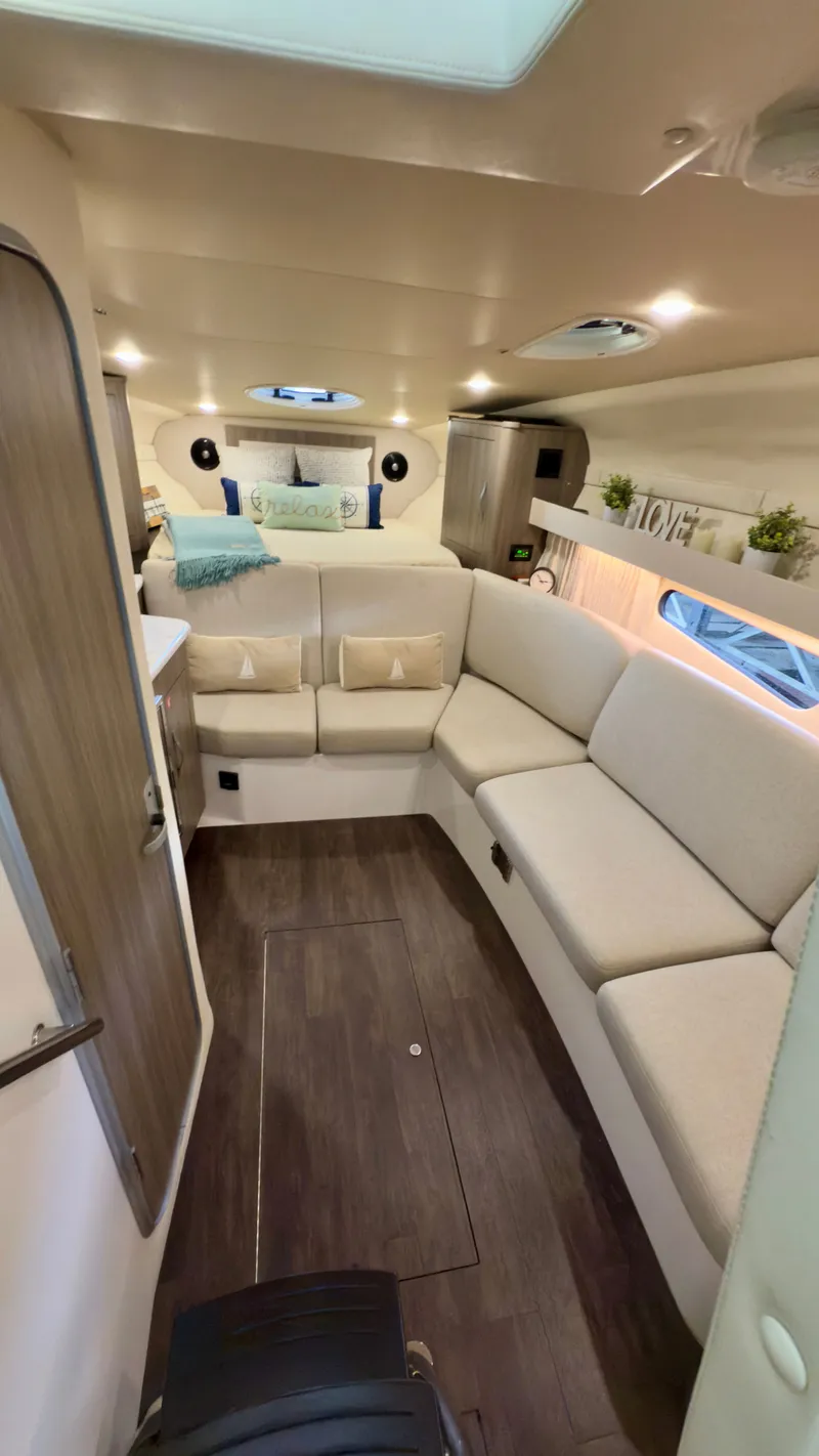 Slide: The Image of 2020 Regal 33 Express interior with cozy seating, modern decor, and elegant wood flooring. - 10