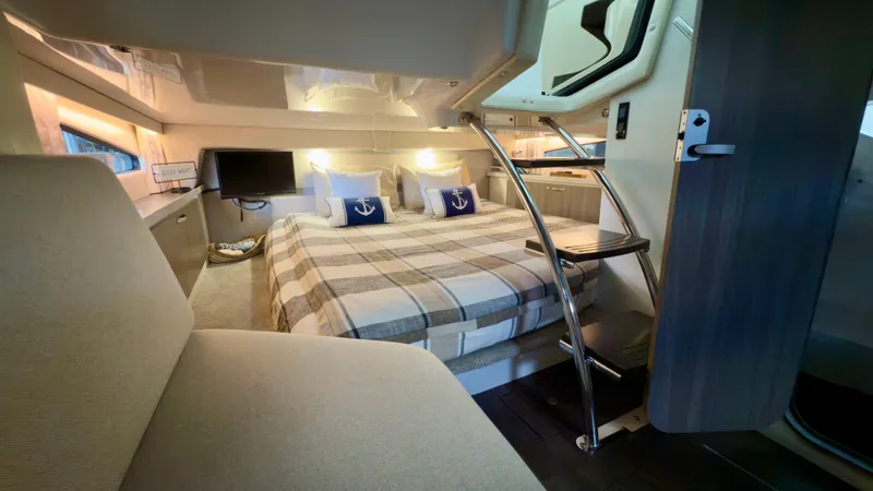 Slide: The Image of Luxurious interior of 2020 Regal 33 Express yacht with cozy bedding and modern amenities. - 11