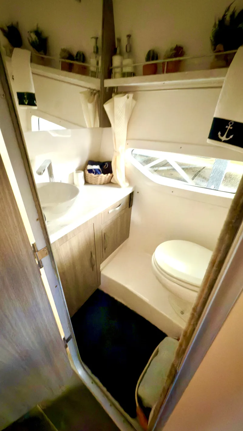 Slide: The Image of 2020 Regal 33 Express boat bathroom with modern fixtures and nautical decor. - 12