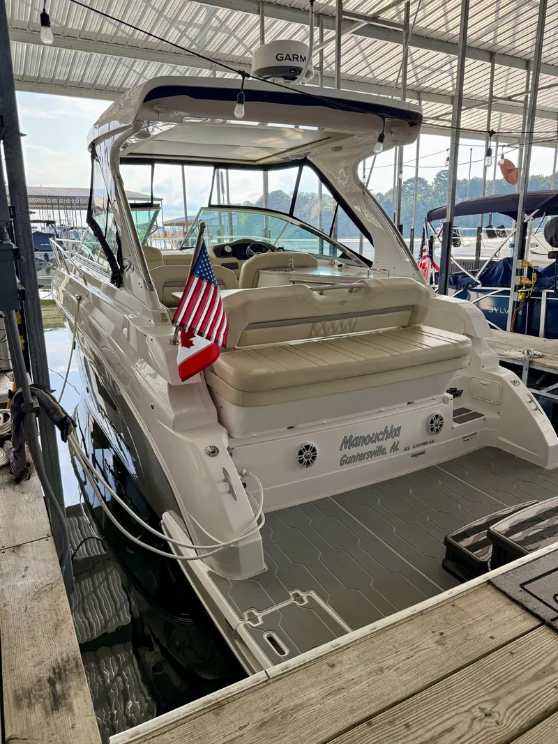 Slide: The Image of 2020 Regal 33 Express boat docked, featuring American and Canadian flags. - 19