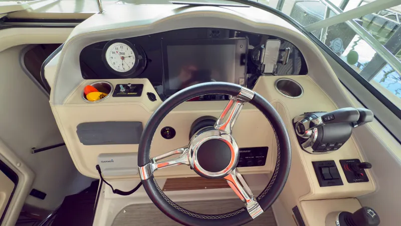 Slide: The Image of Cockpit of 2020 Regal 33 Express boat with steering wheel and control panel. - 2