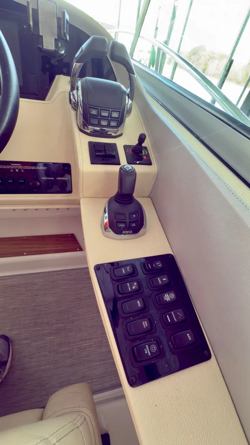 Slide: The Image of Control panel of a 2020 Regal 33 Express boat with joystick and switches. - 3