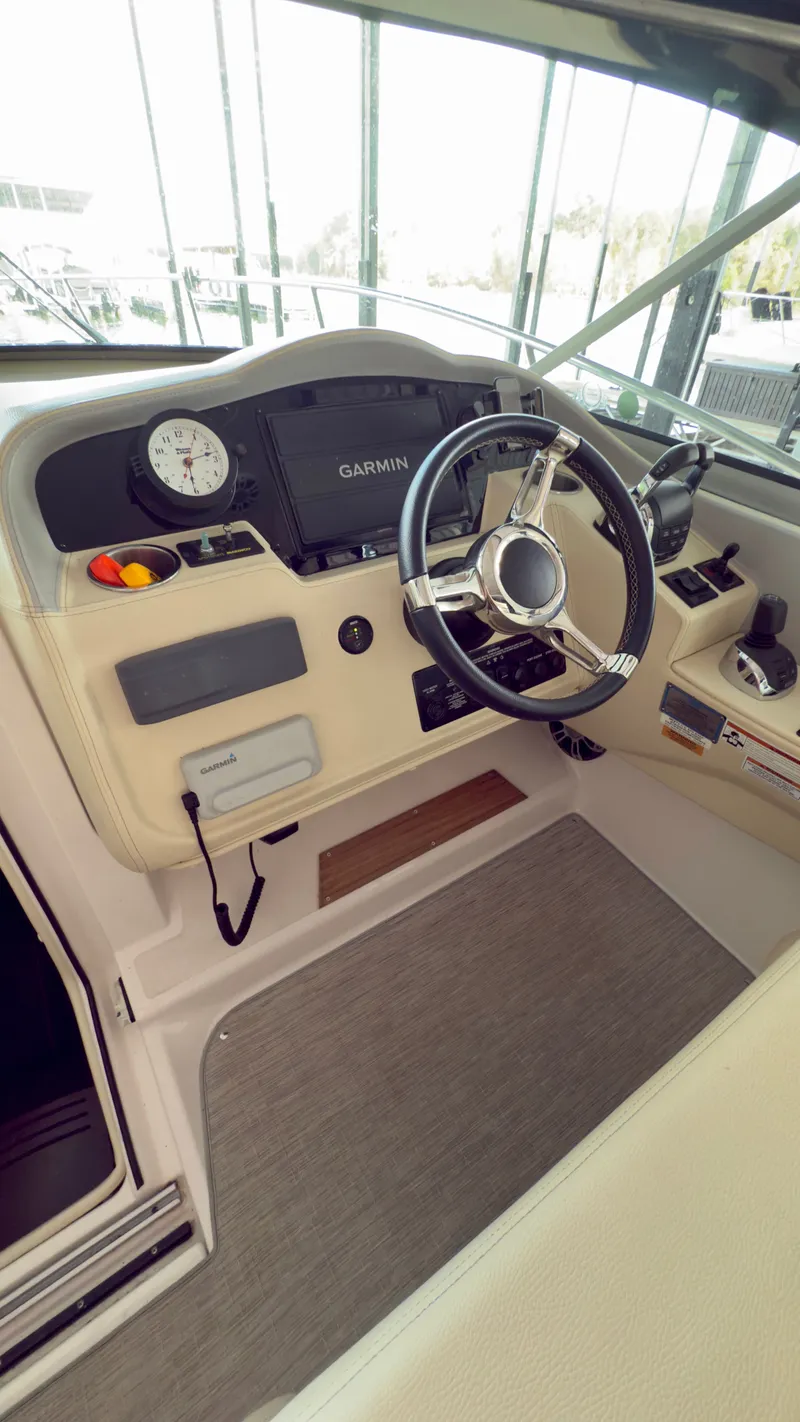 Slide: The Image of 2020 Regal 33 Express helm with Garmin display and modern steering wheel. - 4