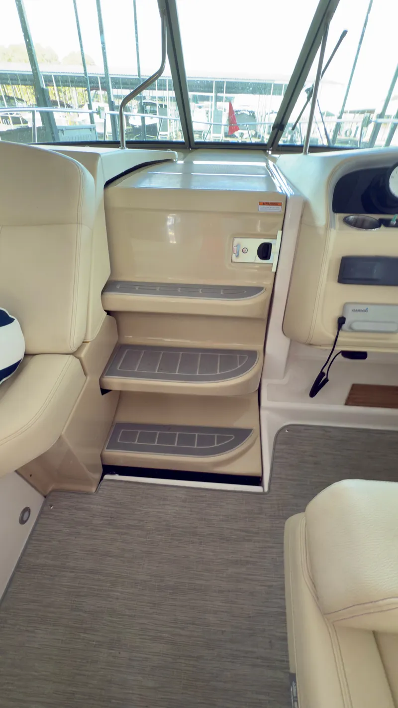 Slide: The Image of 2020 Regal 33 Express interior with beige seating and steps, showcasing luxury design. - 5