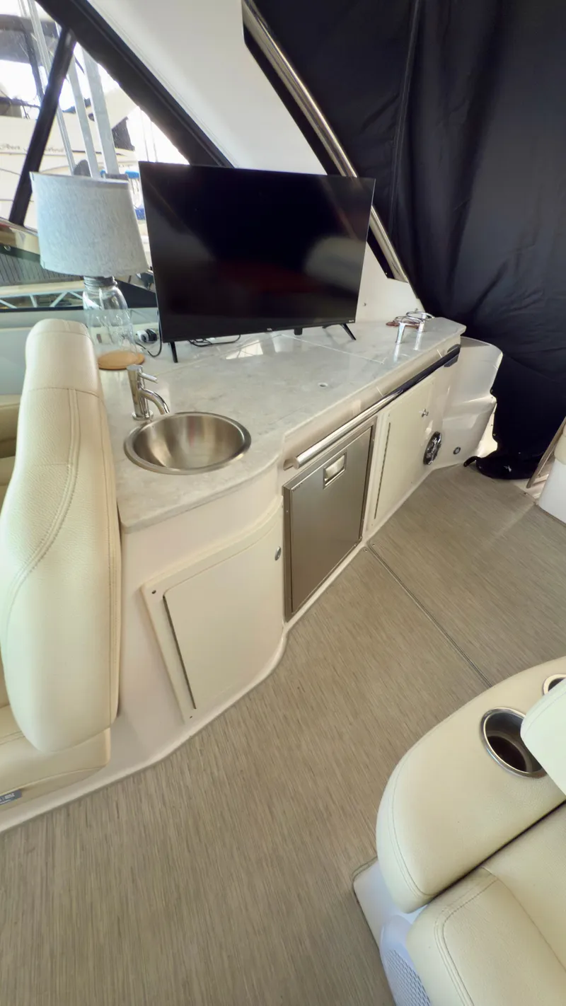 Slide: The Image of 2020 Regal 33 Express yacht interior with kitchenette, sink, and TV. - 7
