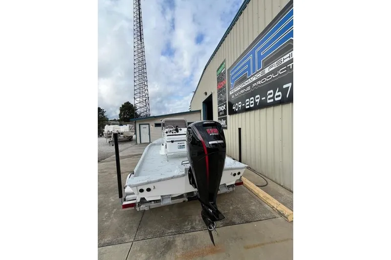 Slide: The Image of 2026 Shoalwater 19 CAT boat with outboard motor at marine shop. - 3