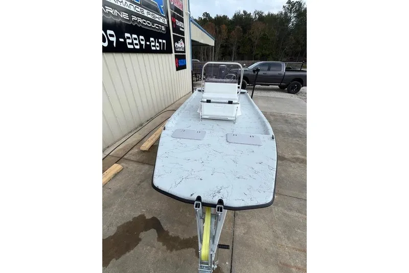 Slide: The Image of 2026 Shoalwater 19 CAT boat on trailer, parked outside a building. - 5