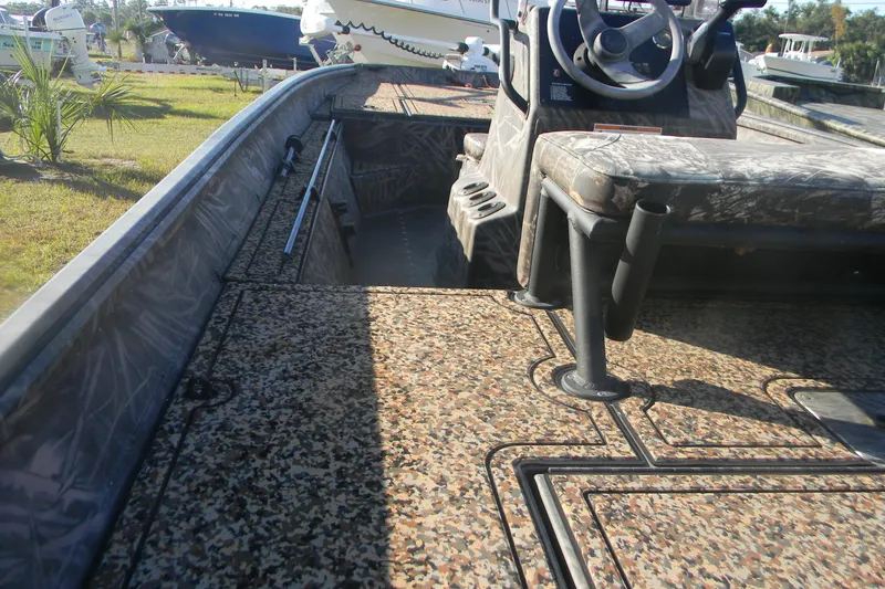 Slide: The Image of 2020 G3 Gator Tough 18 CC boat interior with camo seating and steering console. - 8