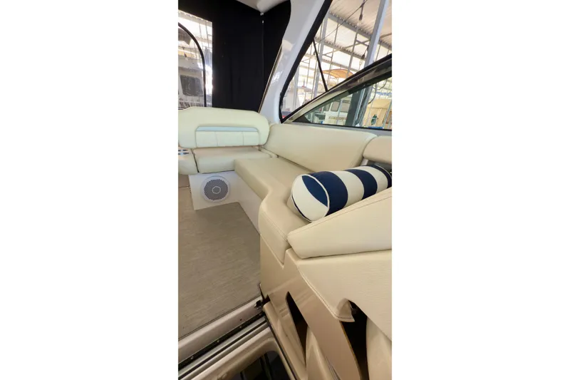 Slide: The Image of 2020 Regal 33 Express boat interior with beige seating and striped cushion. - 10