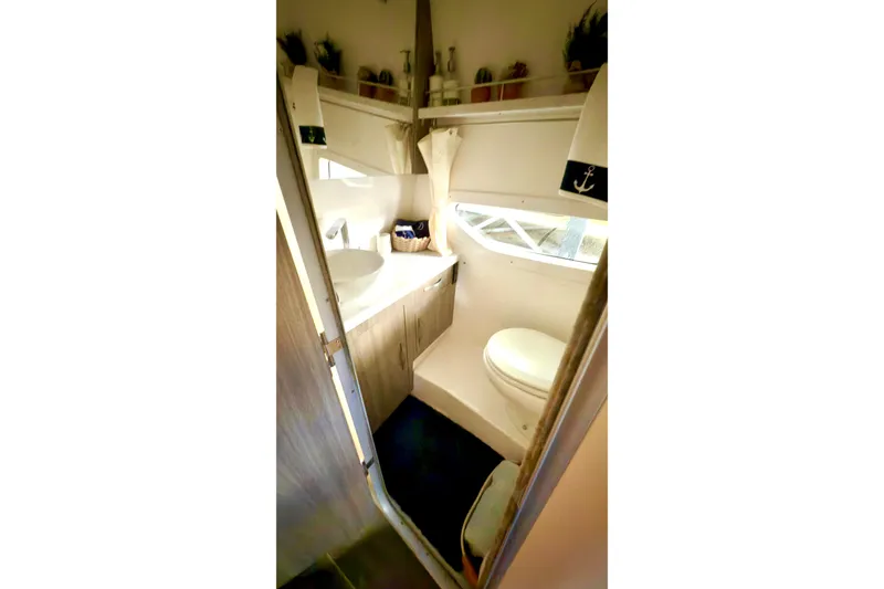 Slide: The Image of 2020 Regal 33 Express boat bathroom with modern fixtures and nautical decor. - 13