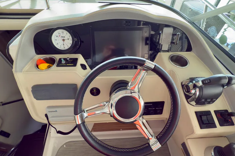 Slide: The Image of 2020 Regal 33 Express boat helm with steering wheel and control panel. - 3
