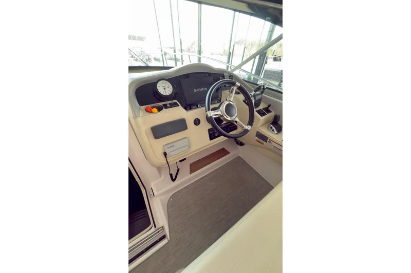Slide: The Image of 2020 Regal 33 Express boat helm with steering wheel and Garmin navigation system. - 5