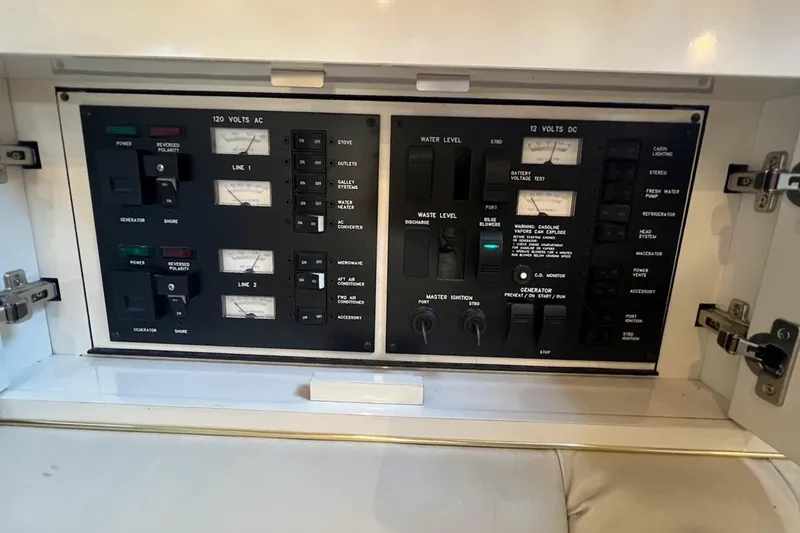 Slide: The Image of Control panel of a 1997 Sea Ray 330 Express boat, featuring various switches and gauges. - 12