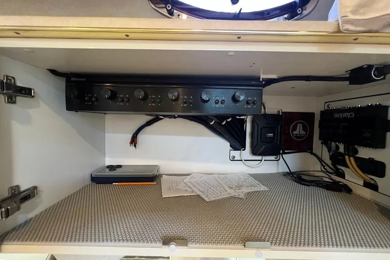 Slide: The Image of 1997 Sea Ray 330 Express interior electronics panel with audio equipment and wiring. - 13