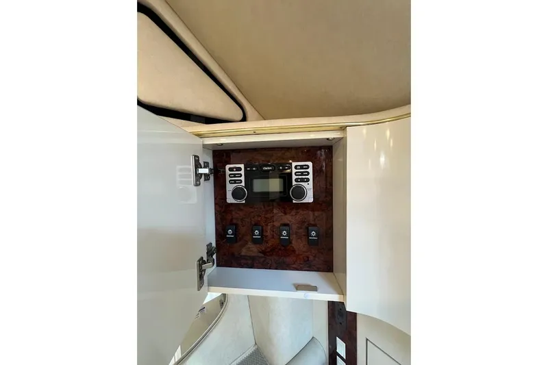 Slide: The Image of 1997 Sea Ray 330 Express cabin control panel with switches and stereo system. - 14