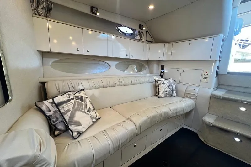 Slide: The Image of Interior of 1997 Sea Ray 330 Express with cream leather seating and modern cabinetry. - 16