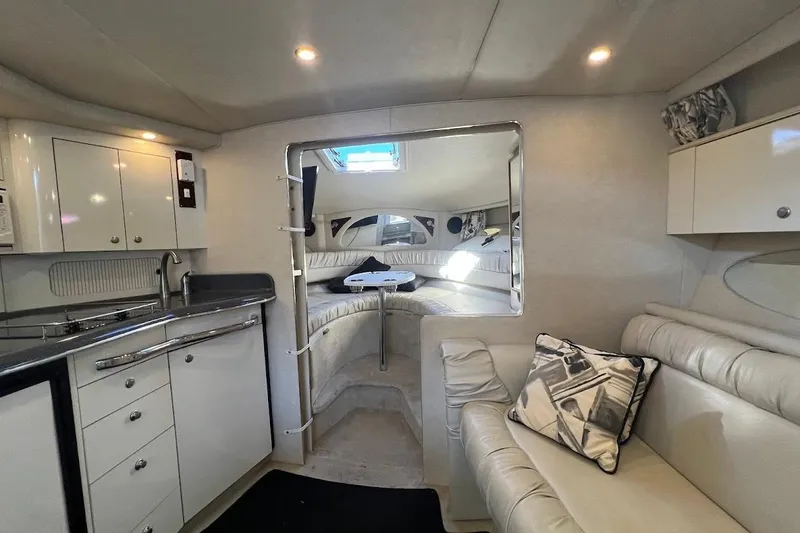Slide: The Image of Interior of 1997 Sea Ray 330 Express yacht with kitchen and seating area. - 17