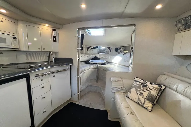 Slide: The Image of Interior of 1997 Sea Ray 330 Express yacht with kitchen and seating area. - 18