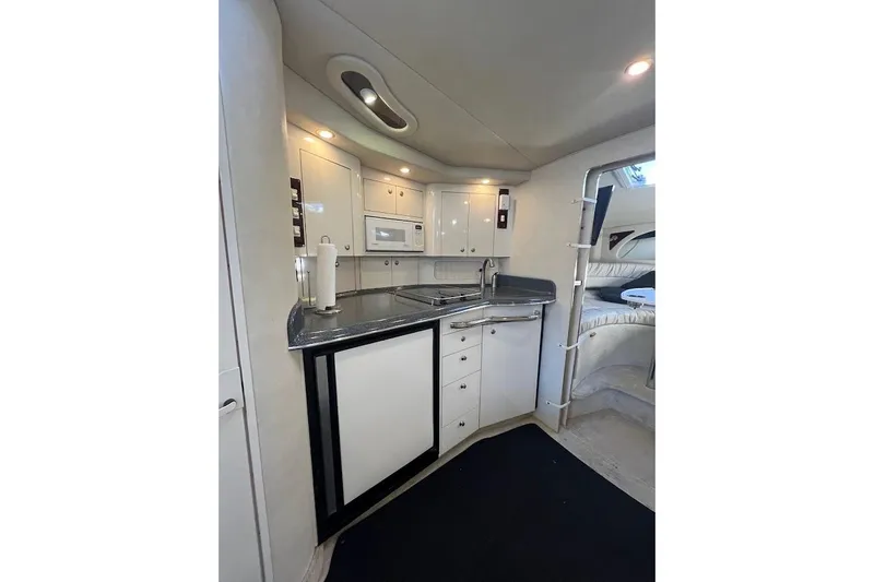Slide: The Image of Interior of 1997 Sea Ray 330 Express yacht with modern kitchen amenities. - 19