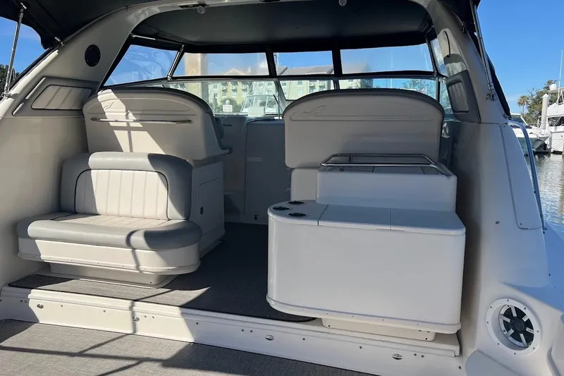 Slide: The Image of 1997 Sea Ray 330 Express boat interior with seating and helm, docked at marina. - 2