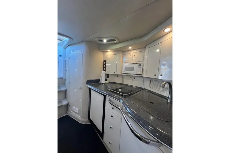 Slide: The Image of Interior of 1997 Sea Ray 330 Express yacht kitchen with modern appliances. - 21