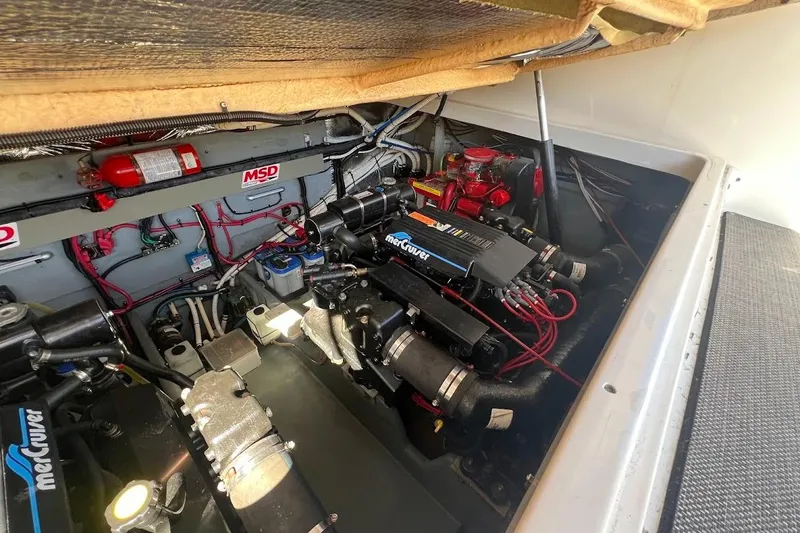 Slide: The Image of Engine compartment of a 1997 Sea Ray 330 Express boat, featuring MerCruiser components. - 25