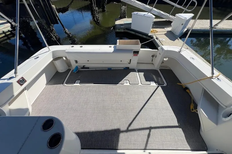 Slide: The Image of 1997 Sea Ray 330 Express boat deck with clean, spacious layout at dock. - 27
