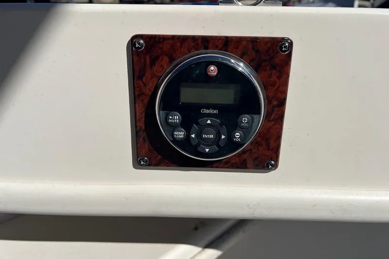 Slide: The Image of Clarion audio control panel on 1997 Sea Ray 330 Express boat dashboard. - 28