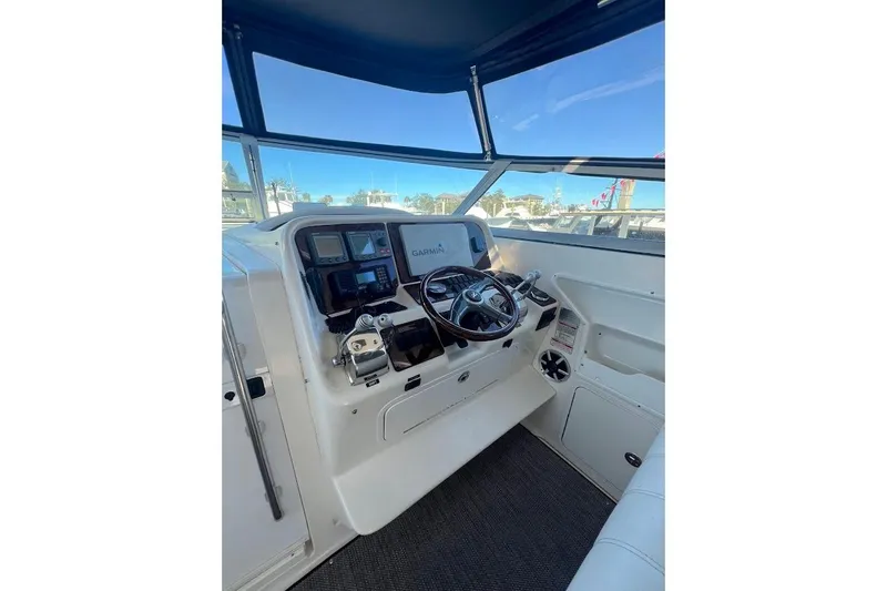 Slide: The Image of 1997 Sea Ray 330 Express helm with Garmin navigation, steering wheel, and control panel. - 5
