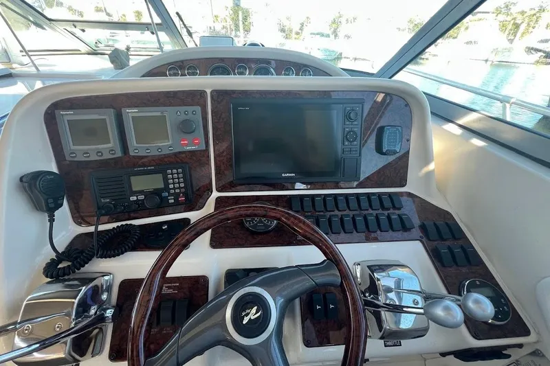 Slide: The Image of 1997 Sea Ray 330 Express helm with navigation equipment and steering wheel. - 7