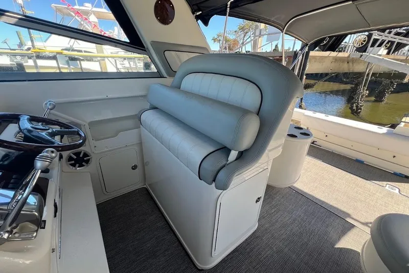 Slide: The Image of 1997 Sea Ray 330 Express boat interior with helm and seating area. - 8