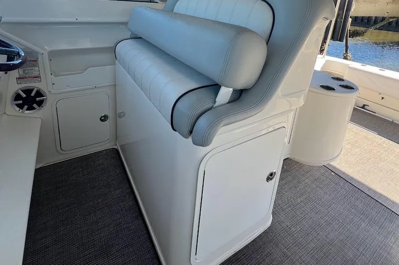 Slide: The Image of 1997 Sea Ray 330 Express boat interior with cushioned seating and storage compartments. - 9