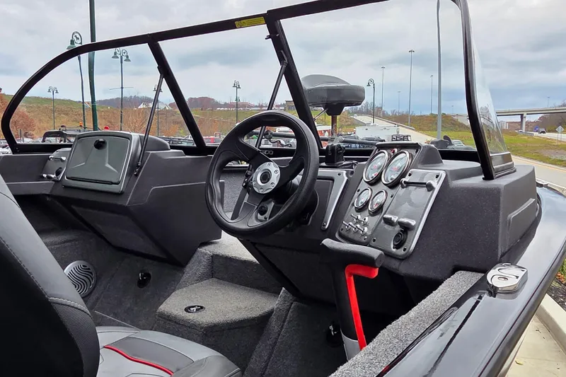 Slide: The Image of 2022 Tracker Pro Guide V-175 WT boat interior with steering wheel and dashboard controls. - 2