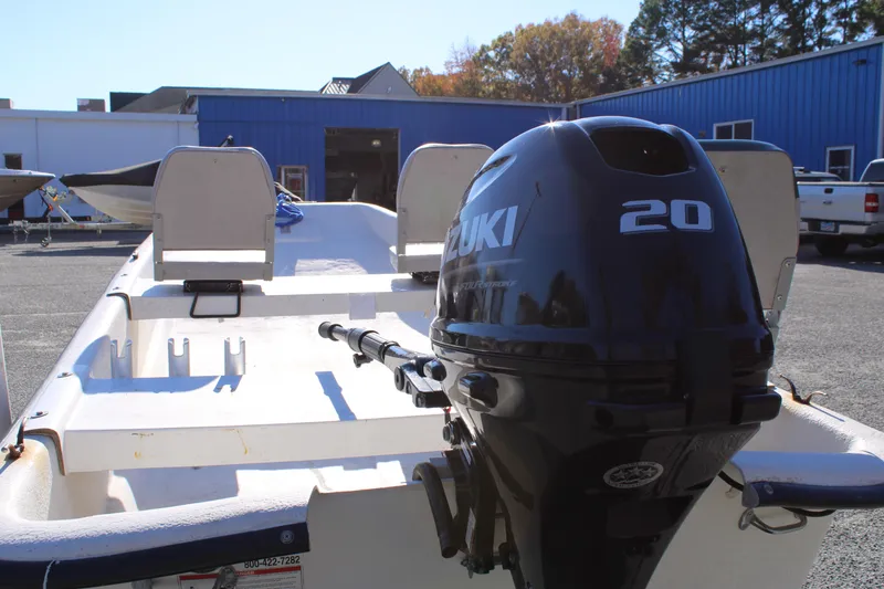 Slide: The Image of 2015 Carolina Skiff J14 CC with Suzuki 20 outboard motor in a boatyard. - 10
