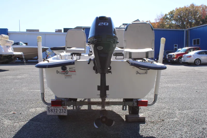 Slide: The Image of 2015 Carolina Skiff J14 CC boat with outboard motor in parking lot. - 2