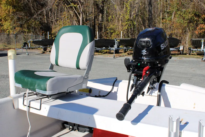 Slide: The Image of 2015 Carolina Skiff J14 CC boat with Suzuki outboard motor and green seat. - 9