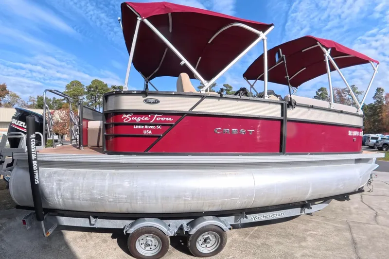 Slide: The Image of 2018 Crest I 220 SLC pontoon boat with spacious seating and wooden deck. - 1