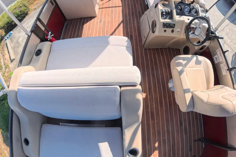 Slide: The Image of 2018 Crest I 220 SLC boat interior with open storage compartment and wooden flooring. - 11