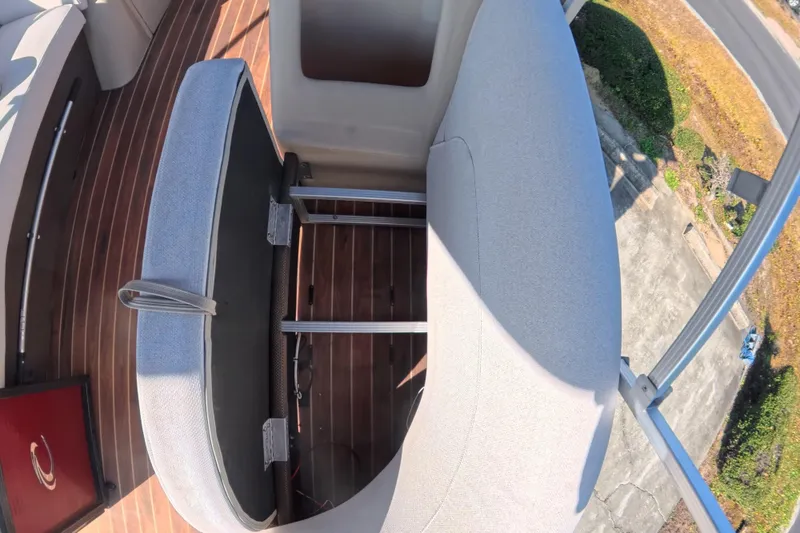 Slide: The Image of 2018 Crest I 220 SLC boat interior with motor and storage compartment. - 12