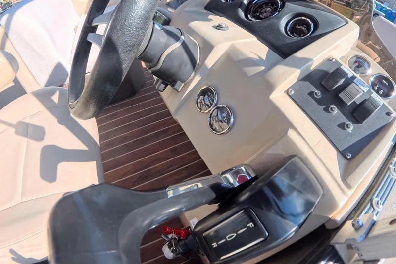 Slide: The Image of Dashboard of 2018 Crest I 220 SLC boat with steering wheel and control panel. - 14