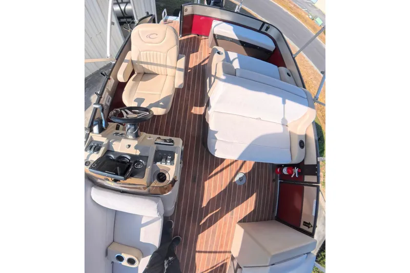 Slide: The Image of 2018 Crest I 220 SLC pontoon boat interior with seating and steering console. - 17