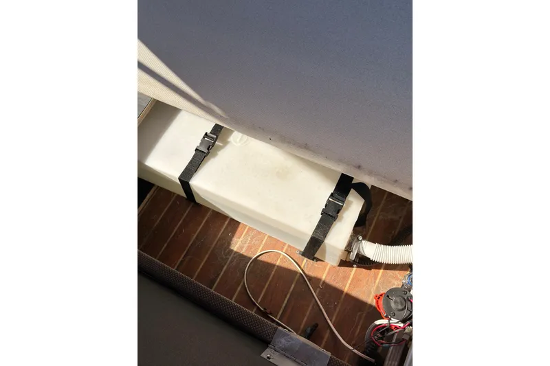 Slide: The Image of 2018 Crest I 220 SLC boat interior with cushioned seating and wood flooring. - 19