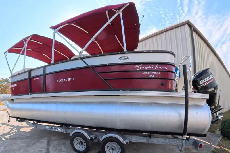 Slide: The Image of 2018 Crest I 220 SLC pontoon boat with red canopy on trailer. - 3