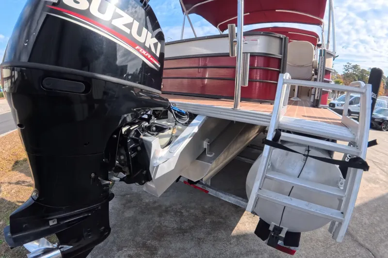Slide: The Image of 2018 Crest I 220 SLC pontoon boat with Suzuki outboard motor and ladder. - 5