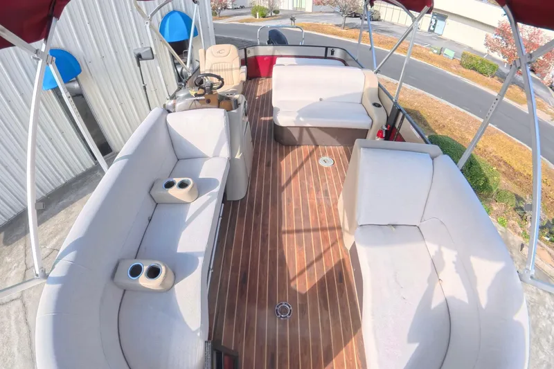 Slide: The Image of 2018 Crest I 220 SLC pontoon boat with red canopy and spacious seating. - 6